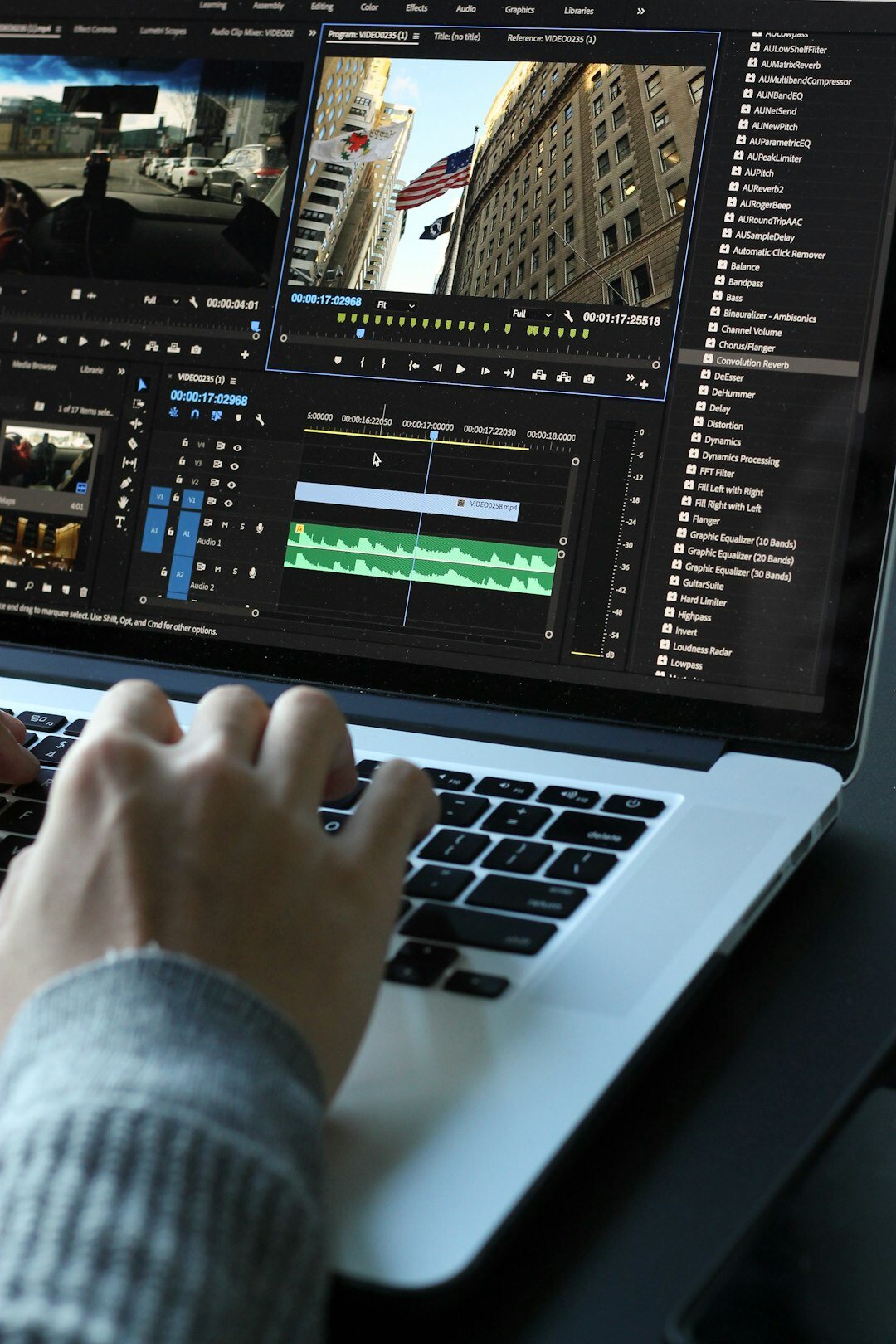 Production team reviewing footage and a coordination checklist on a laptop