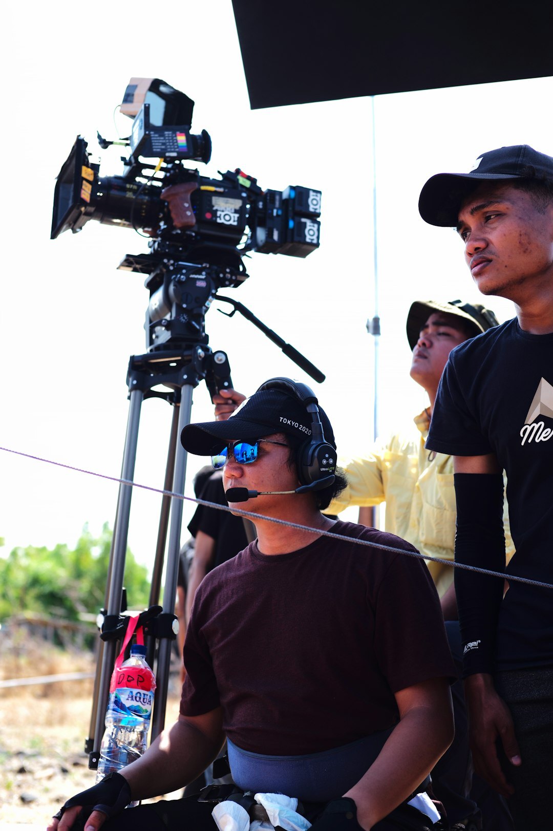 Reporter with a microphone briefing a field crew