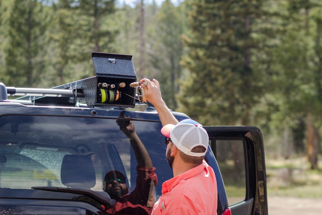 Field crew setting up a camera near a satellite van